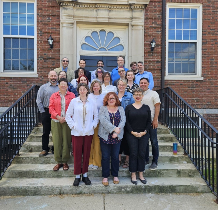 English department faculty standing on building steps