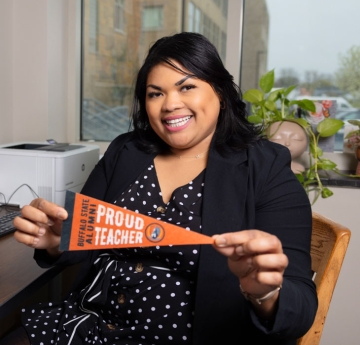 Alumni teacher holding a pennant
